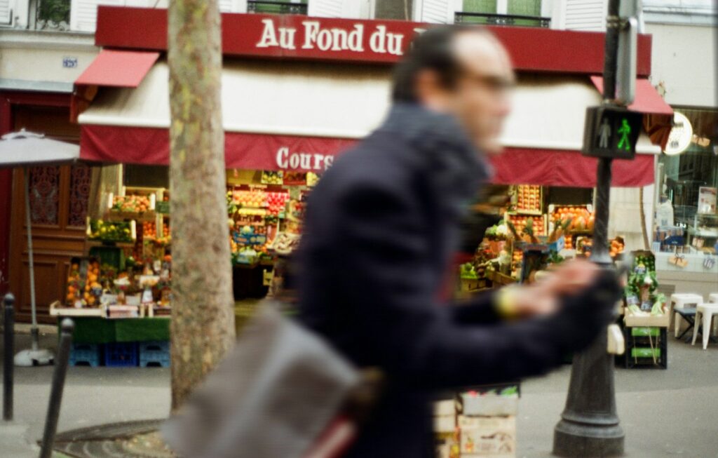 Overdekte voedselmarkt in Parijs met kramen vol groente en kaas